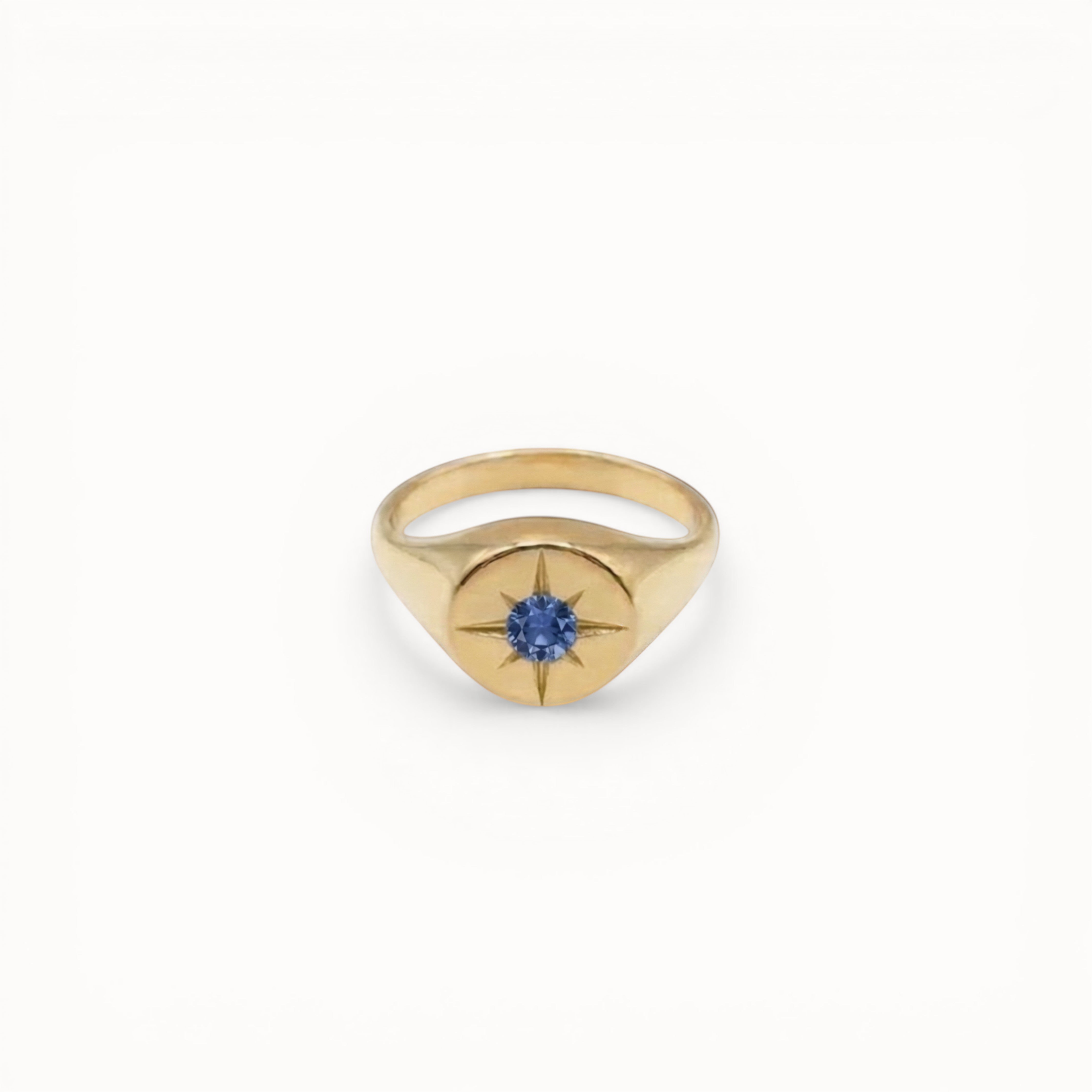 Loen Jewelry gold signet ring with blue sapphire starburst center. Inspired by Parisian New Wave.
