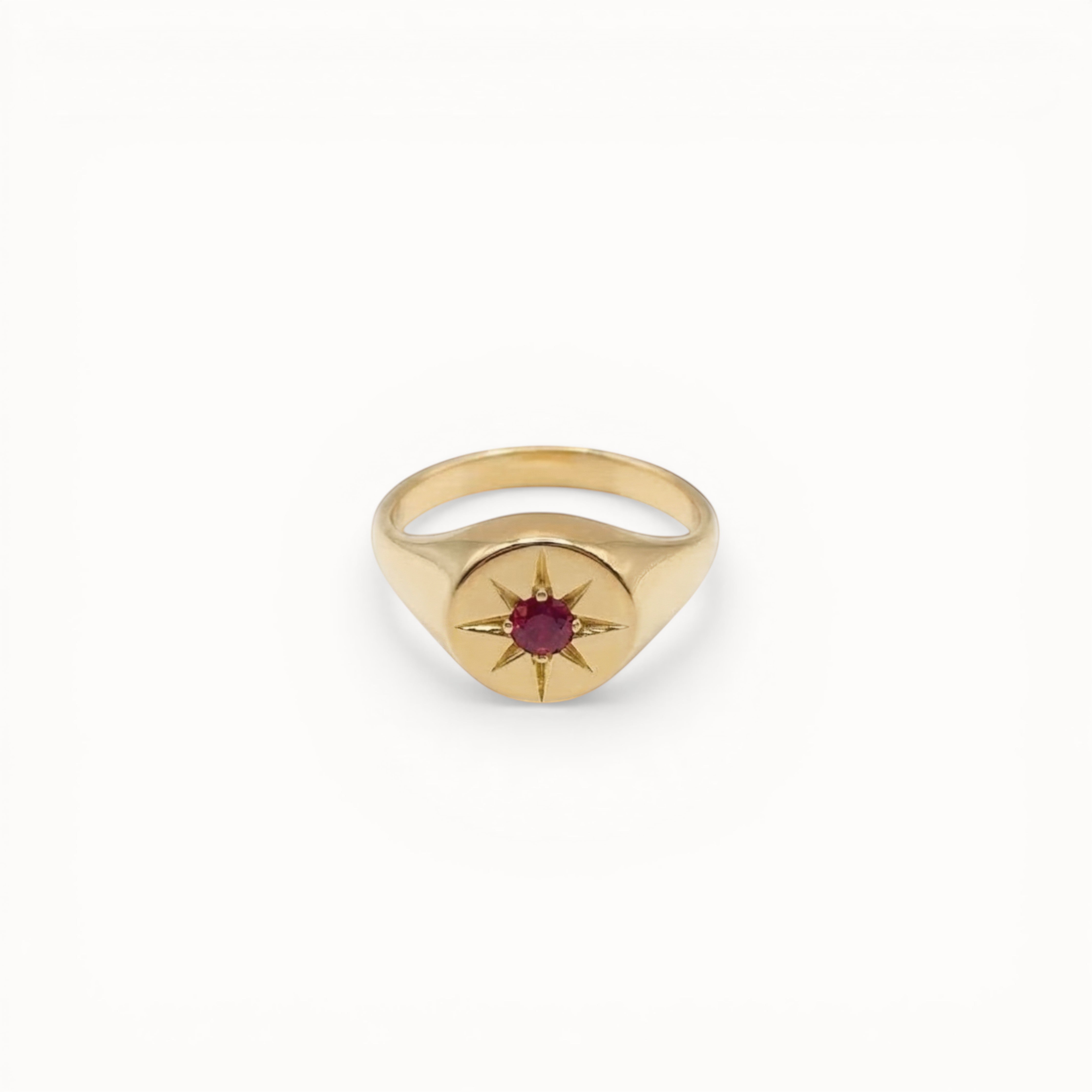 Loen Jewelry gold signet ring with red starburst gemstone, inspired by Parisian New Wave.